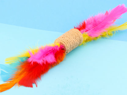 Jute rope barrel shaped rattle toy with bright turkey feathers at each end